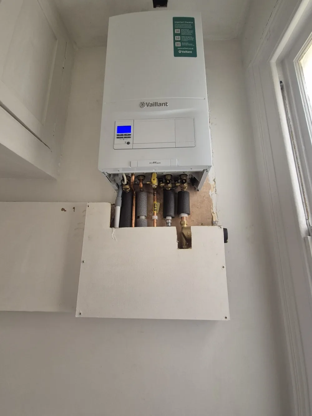 Underside of a domestic boiler with copper heating pipework