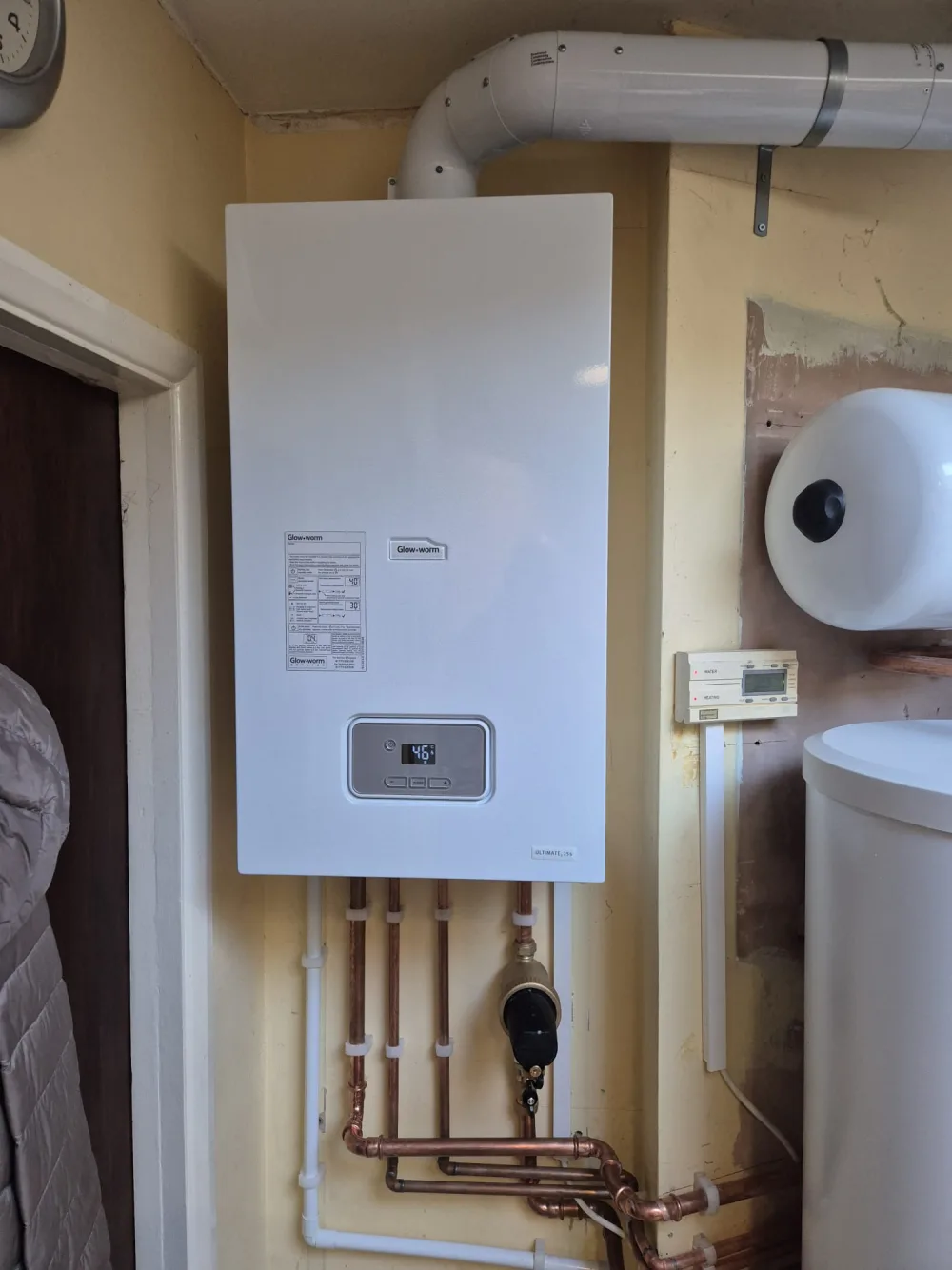 Wall-mounted domestic boiler with system connections below