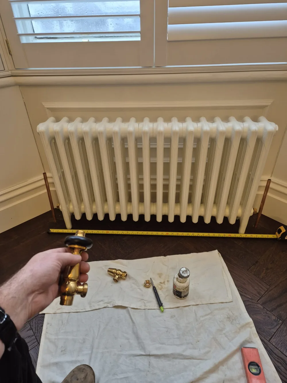 White panel radiator with heating valve components