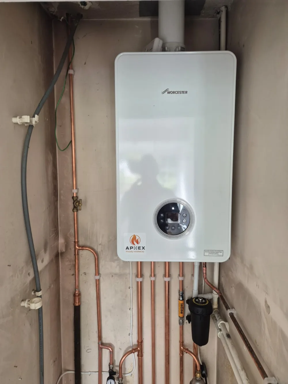 Wall-mounted boiler in a domestic utility room
