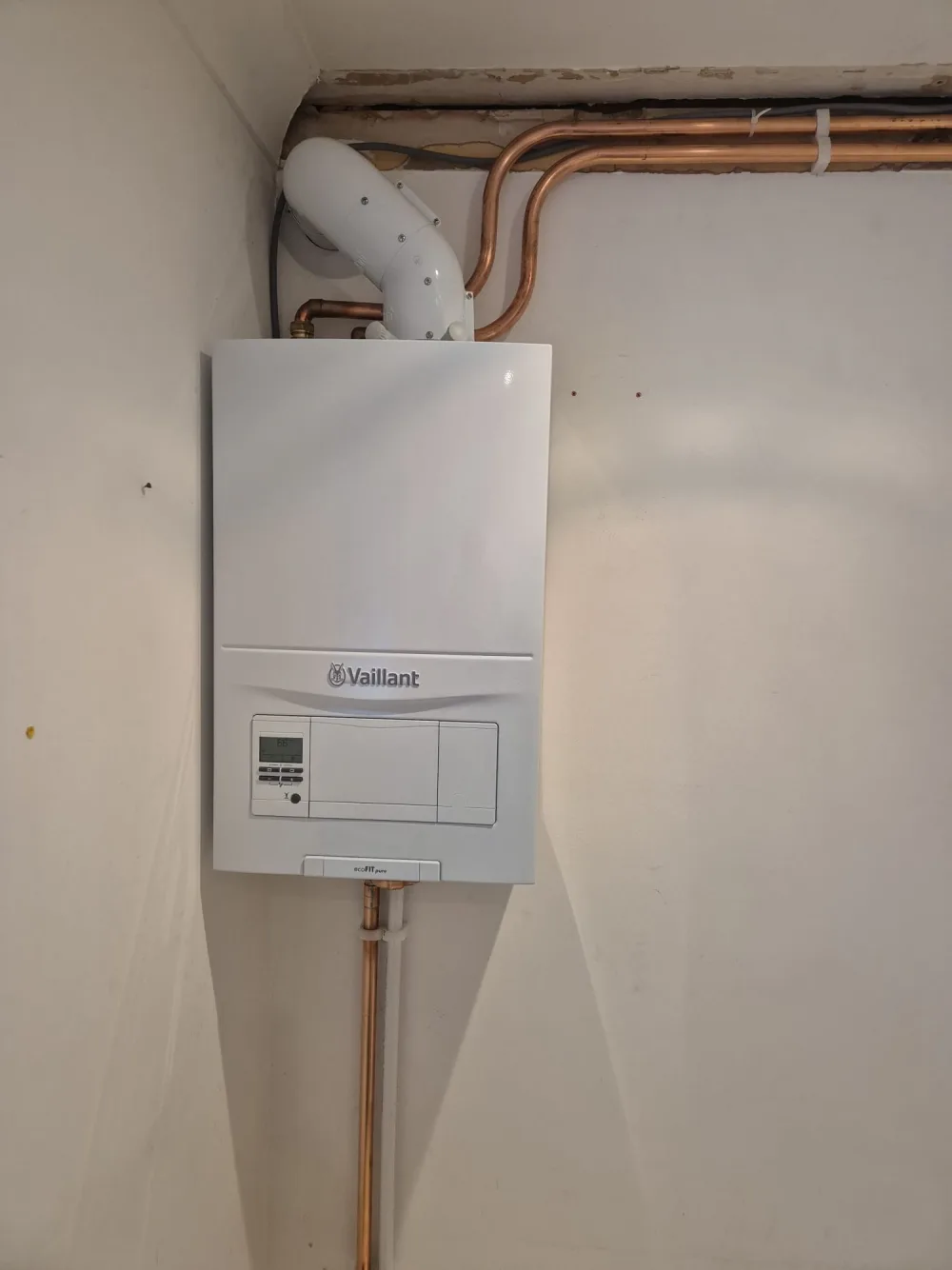 Wall-mounted domestic boiler fitted in a wall cupboard