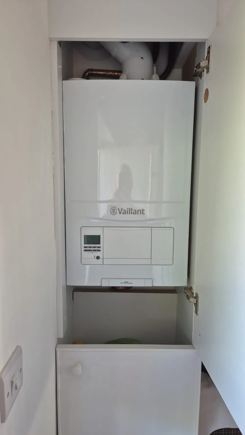 Wall-mounted domestic boiler in a utility space